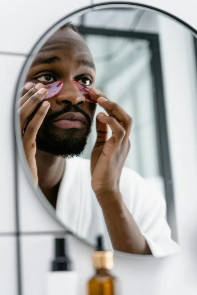 Man applying under eye cream for dark circles and puffiness