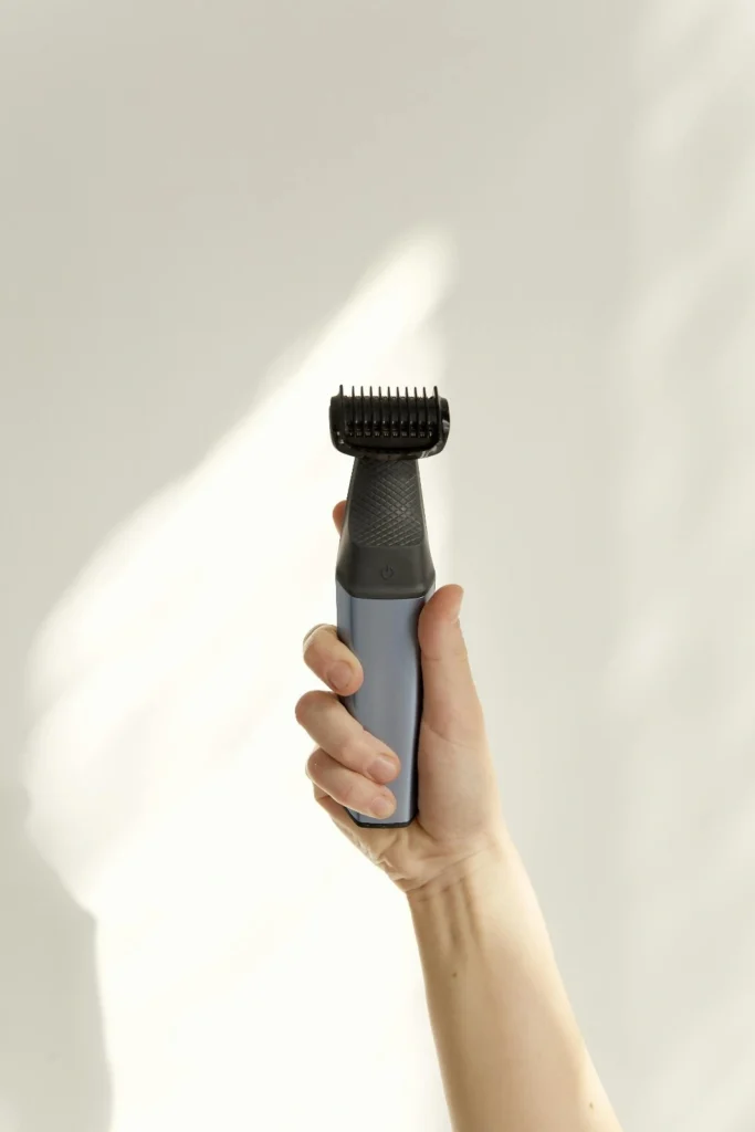 Beard trimmer in hand showing difference between trimmer and shaver
