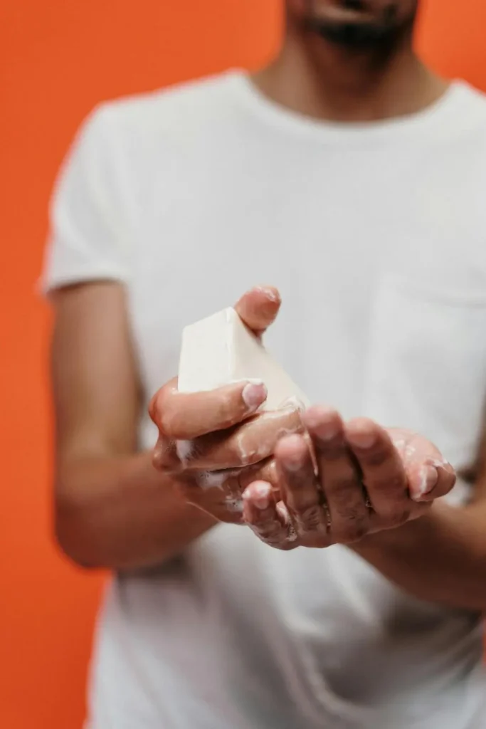 man washing face with soap