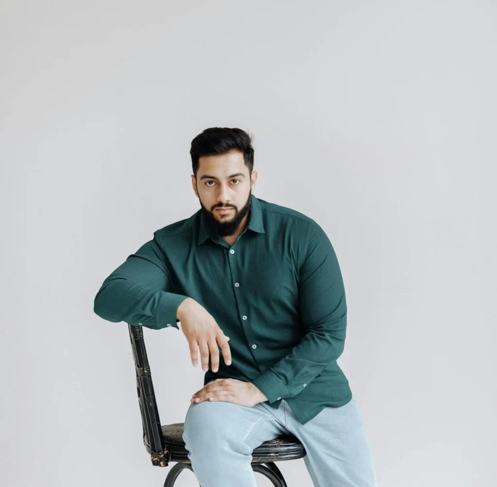 Man with well-groomed beard sitting confidently